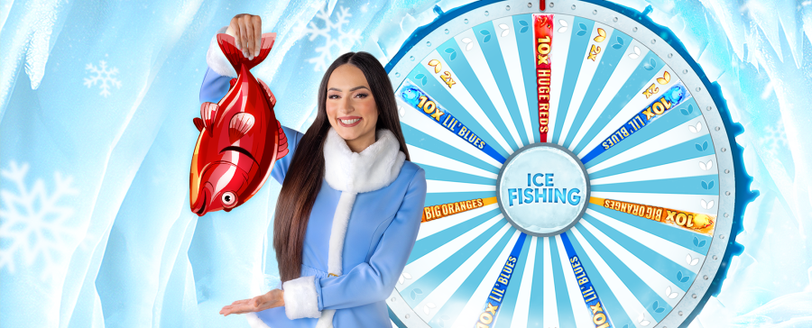Smiling live casino host holding a red cartoon fish in front of the Ice Fishing game wheel – exclusive Arctic-themed experience. - partycasino